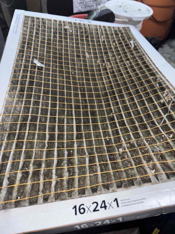 Responded to no cooling complaint on 10-year-old residential air conditioning system. Upon inspection, found severely restricted airflow due to heavily clogged 16x24x1 air filter and excessive dust accumulation on blower wheel assembly. Replaced dirty filter with new unit and cleaned blower wheel and surrounding ductwork to restore proper airflow. System tested and confirmed operational with adequate cooling output restored to all areas of residence.
