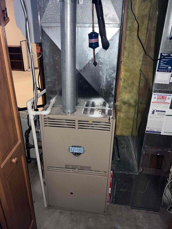 Conducted on-site evaluation for water heater replacement and sump pump system installation in basement utility area. Assessed existing dual 40-gallon water heater configuration and provided estimate for consolidation to single 50-gallon unit, including necessary plumbing modifications to accommodate updated capacity and connections to existing copper and PVC supply lines. Evaluated current sump pump system and provided quote for primary sump pump replacement along with battery-powered backup system installation to ensure flood protection redundancy. Documented existing mechanical room layout, including proximity to furnace, HVAC ductwork, water softener system, and available clearances for equipment access and code compliance.