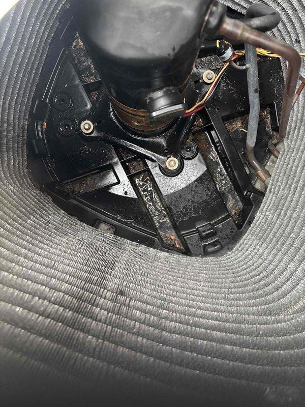 Responded to no cooling complaint on nine-year-old air conditioning system where indoor fan was operating but air temperature remained warm throughout home. Performed diagnostic inspection of outdoor condensing unit, including examination of compressor motor assembly, electrical connections, and evaporator coil components. Documented condition of compressor unit, wiring harness with terminal connections, and mounting hardware for service records.
