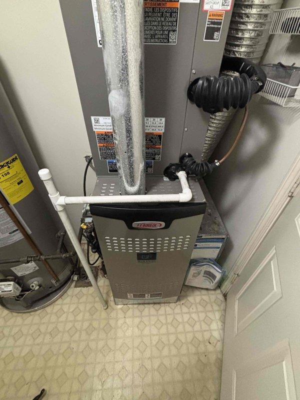 Completed comprehensive BFMA tune-up service on Lennox furnace system and water heater during morning appointment window. Upon arrival, discovered extensive frost and ice accumulation on refrigerant line of air handler unit, indicating potential refrigerant charge issue or restricted airflow requiring further diagnostic evaluation. Performed carbon monoxide testing using calibrated detector to verify safe combustion levels and system operation. Inspected all equipment labels, safety warnings, and manufacturer specifications for compliance. Completed standard maintenance procedures including visual inspection of furnace components, ductwork connections, condensate drain lines, and mechanical room installation. System operational at time of service completion, though refrigerant line icing condition noted for customer awareness and potential follow-up service recommendation.