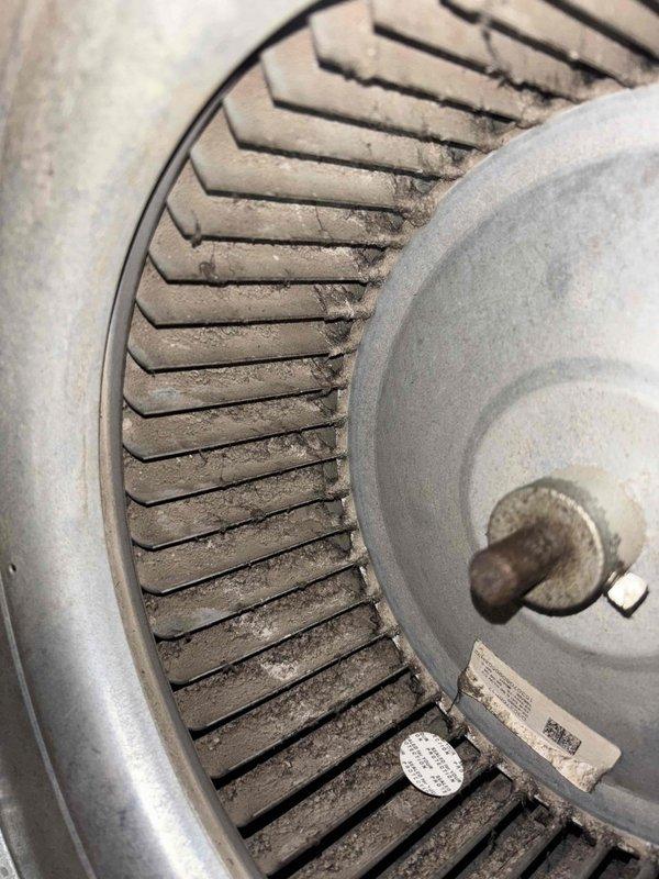 Responded to commercial no cooling call where thermostat was not communicating with unit. Upon inspection, found blower motor and wheel heavily contaminated with dust and debris accumulation, causing operational issues. Removed and cleaned blower assembly components, including squirrel cage fan wheel and motor housing. Verified motor functionality and reassembled unit. System restored to proper operation with thermostat communication reestablished.