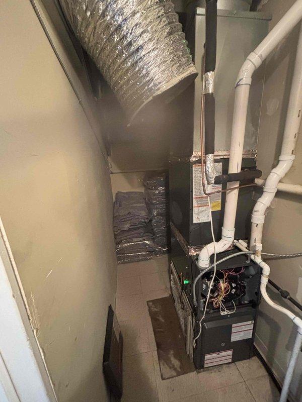 Responded to no cooling call with unit freezing over. Upon arrival, located furnace and air handler in interior utility closet rather than roof as initially suspected. Inspected system and found evaporator coil icing condition indicating restricted airflow or refrigerant issue. Documented equipment configuration and conditions with photos for diagnostic reference. Customer advised of findings and collected payment at time of service as requested.