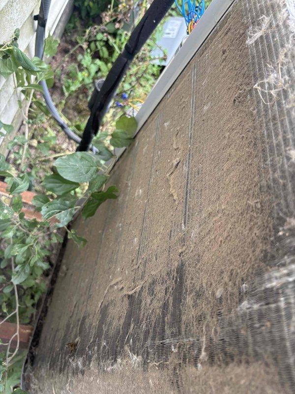 Completed comprehensive BFMA tune-up service on outdoor air conditioning condenser unit aged 4+ years. Unit exhibited heavy accumulation of dirt, dust, and debris on exterior panels, filter covers, and aluminum cooling fins, with visible damage to fin spacing and compression in several areas. Performed thorough cleaning of condenser coils, straightened bent fins to restore proper airflow, removed caked-on debris from exterior surfaces and filter components, and cleared vegetation growth from base perimeter. Inspected electrical connections at service panels and conduit runs, verified proper operation of all components, and restored unit to optimal efficiency standards. System now operating within manufacturer specifications following maintenance protocol.