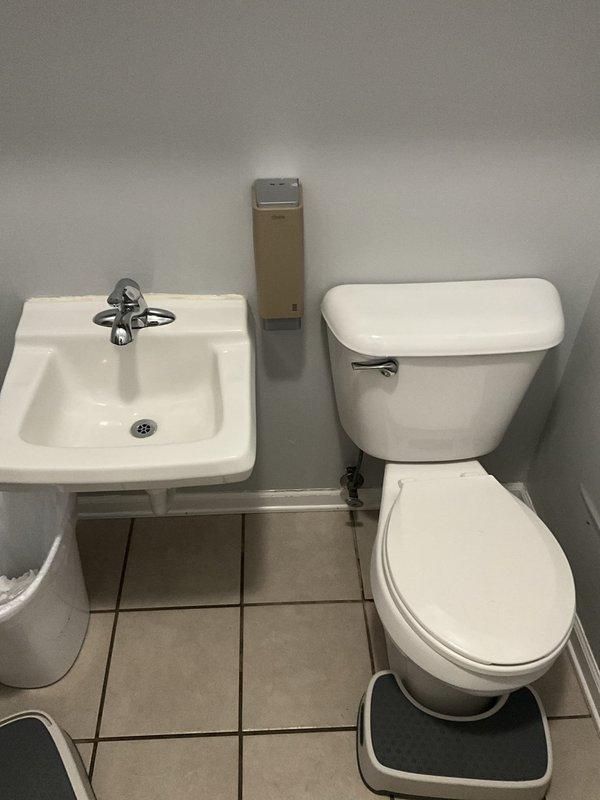 Responded to service call for non-flushing toilet in commercial bathroom. Upon arrival, inspected standard white porcelain toilet and confirmed flushing mechanism was not operating properly. Diagnosed blockage in drain line, performed augering procedure to clear obstruction, and restored proper flushing function. Tested toilet multiple times to verify complete resolution and left facility in clean, operational condition.
