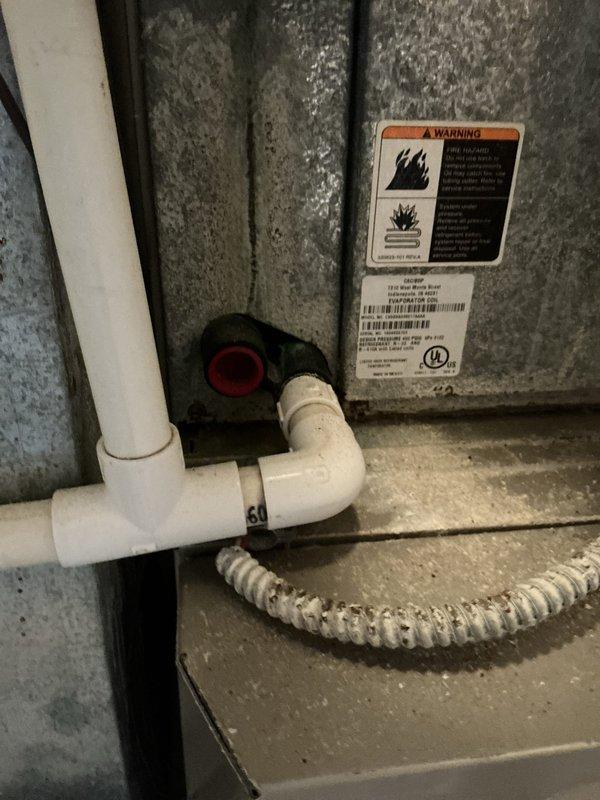 Conducted comprehensive HVAC system evaluation for aging air conditioning and furnace units exceeding 25 years of service life. Documented existing equipment condition including outdoor condenser unit with weathered grille work and interior furnace components with associated condensate drainage system, photographed all major components and provided full system replacement estimate with recommended 4-6 window installation timeline.