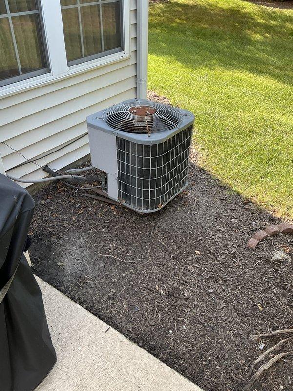 Conducted comprehensive HVAC system evaluation for aging air conditioning and furnace units exceeding 25 years of service life. Documented existing equipment condition including outdoor condenser unit with weathered grille work and interior furnace components with associated condensate drainage system, photographed all major components and provided full system replacement estimate with recommended 4-6 window installation timeline.