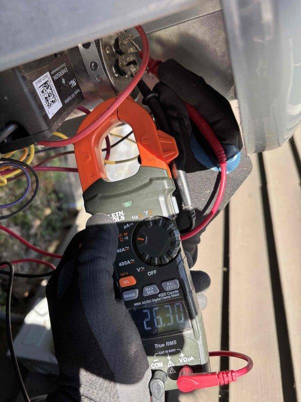 Completed comprehensive air conditioning tune-up on 5-year-old system. Performed visual inspection of ductwork using borescope camera, revealing normal dust accumulation in flexible ducting. Measured electrical parameters using digital multimeter, recording amperage readings of 23.30 amps to verify proper compressor operation and system performance within manufacturer specifications.