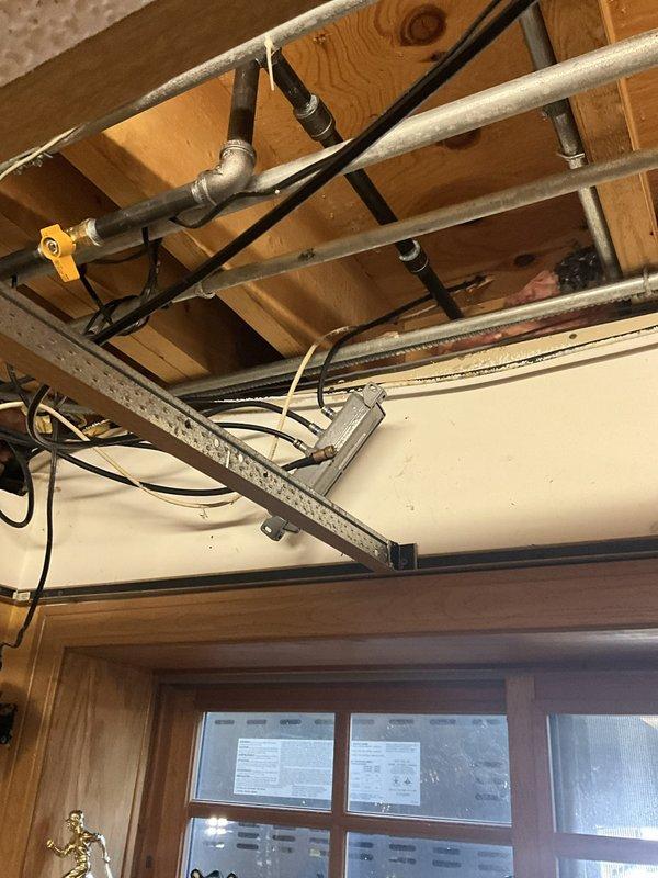 Shut off main gas supply to residence and safely relieved all gas pressure from existing system. Cut into existing fireplace gas line and installed new gas piping route through basement ceiling joists to exterior back patio location above basement window on right side of home. Installed yellow gas shut-off valve, black iron pipe, necessary fittings, and proper supports to code specifications, terminating at patio area to supply new outdoor gas grill and patio heater. All work completed with 1-year warranty coverage.