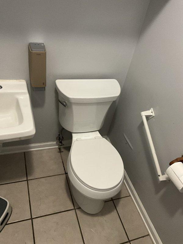 Removed and disposed of existing toilet from commercial powder room located near rear staircase. Installed new Kohler toilet with new wax ring, closet bolts, and water supply line. Verified proper seal and functionality upon completion.
