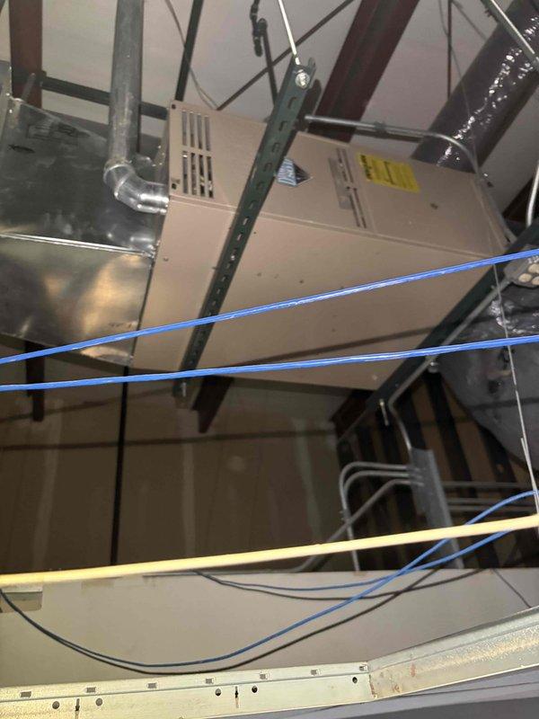 Responded to service call for commercial air conditioning system not turning on. Performed diagnostic inspection of rooftop air handler unit installed in attic space. Accessed internal components and inspected electrical connections, capacitor, and control wiring. Identified system failure and documented equipment condition including visible corrosion on internal metal surfaces. Completed troubleshooting and provided diagnostic findings to customer.