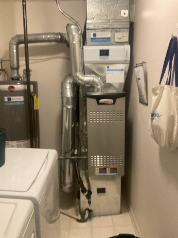 Completed comprehensive BFMA tune-up service on residential HVAC system including furnace, humidifier, and tanked water heater. Performed standard maintenance procedures on gas furnace unit with perforated cabinet, inspected and cleaned air filtration system with pleated media filters showing moderate dust accumulation, serviced humidifier unit with #10 pad replacement, and conducted full inspection of tanked water heater including burner assembly and safety controls. All equipment tested and verified operational, ductwork connections inspected, and system confirmed ready for heating season.