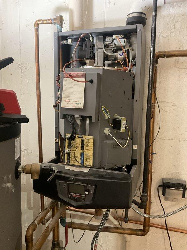 Completed annual boiler maintenance including inspection of combustion chamber assembly, blower motor, gas valve controls, and all electrical connections. Verified proper operation of ignition system, heat exchanger, digital control board, and all safety devices. Cleaned and tested unit, confirmed all copper piping connections and brass valves secure with no leaks detected.