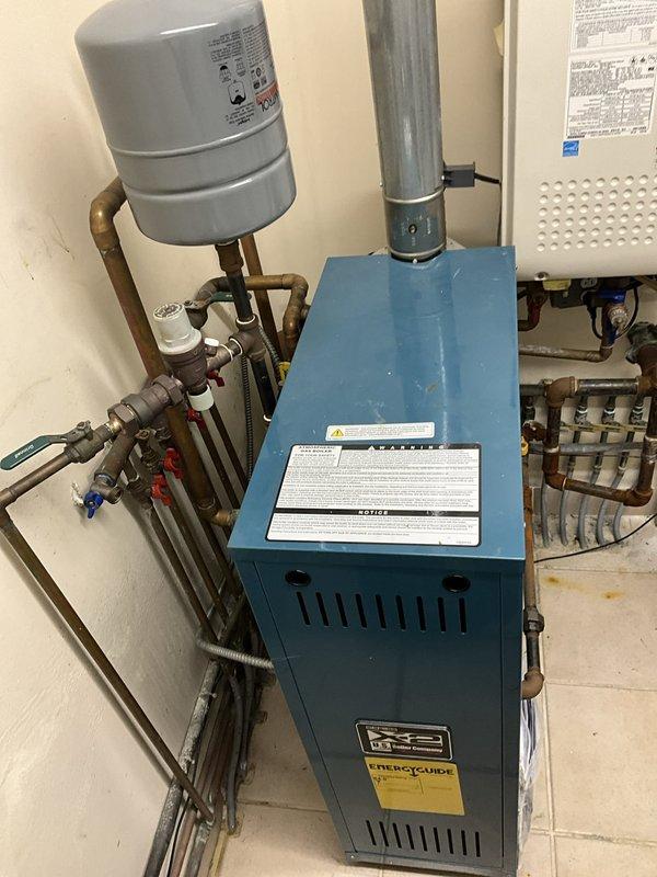 Completed routine maintenance on residential heating system including radiant floor boiler and two furnaces approximately one year old. Performed comprehensive tune-up procedures on all three units, inspected thermostat operations, verified proper boiler circulation and expansion tank pressure, checked all safety controls and flue connections, and confirmed system functionality with no issues found.