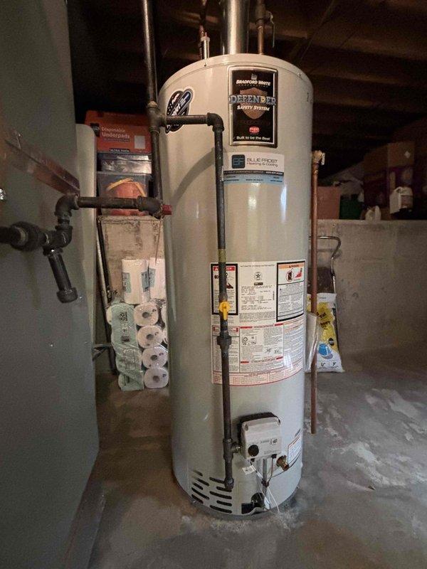 Completed comprehensive BFMA tune-up on 9+ year old furnace system during morning service window. Performed standard maintenance protocol including inspection of all major components, verified proper operation of heating system, and evaluated air filter condition. Documented equipment condition with photos showing current Honeywell pleated air filter and basement mechanical room setup including water heater and electrical connections.