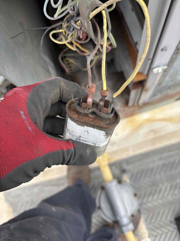 Completed scheduled BFMA preventive maintenance on 22-year-old commercial rooftop unit including filter replacement and belt inspection. Replaced air filters per quarterly maintenance schedule and verified proper fitment in filter rack system. During inspection, identified heavily corroded capacitor with significant rust buildup on terminals and oxidized wire connections, indicating potential failure risk that will require replacement to maintain system reliability.