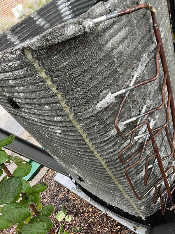 Completed comprehensive BFMA tune-up service on residential air conditioning system, performing electrical diagnostics with amp draw readings of 57.9 amps and voltage testing on outdoor unit. The condenser coil exhibited heavy accumulation of dust, debris, lint, and fibrous material throughout the fin assembly, which was addressed during the maintenance service to restore proper airflow and system efficiency.