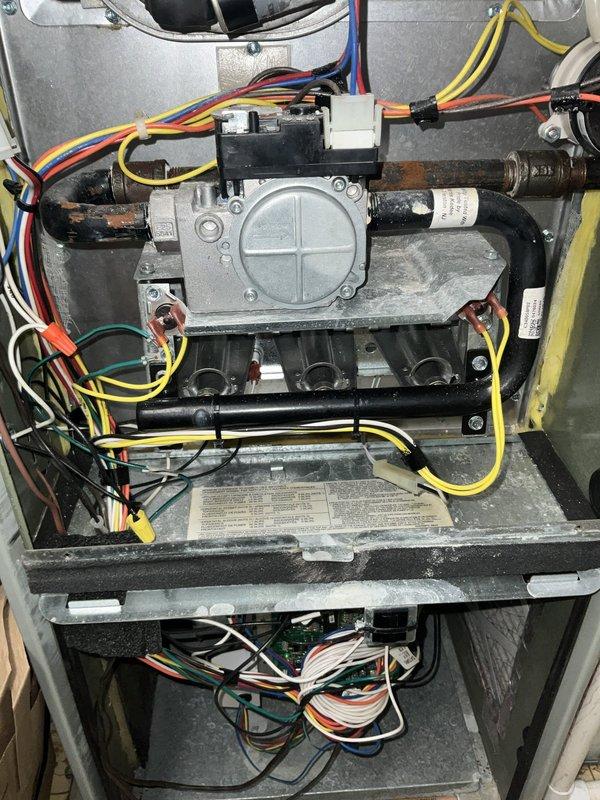 # HVAC Service - No Heat Call

Responded to no heat call on 7-year-old furnace located in closet/utility/laundry room. Upon arrival, performed diagnostic inspection of furnace control system and gas valve assembly. Accessed control panel and examined circuit boards, wiring harnesses, and electronic components for proper operation. Inspected gas valve, burner manifold, and associated piping for functionality and safety. Verified all electrical connections, including multi-conductor wiring and control circuits. Documented equipment condition through photographs showing control board assembly and gas valve system. All components inspected and tested to restore heating operation. System returned to normal working condition.