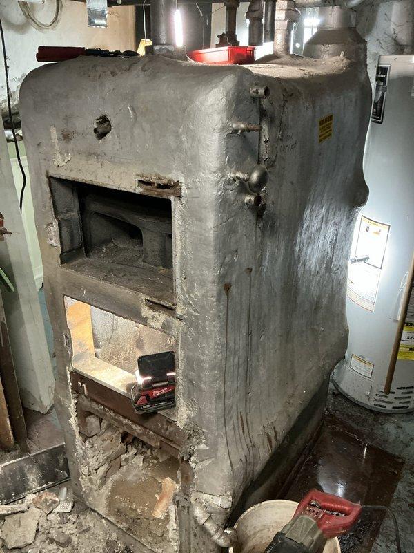 Removed and replaced severely deteriorated steam boiler system in basement mechanical room. The existing unit exhibited extensive corrosion, structural degradation, and compromised masonry housing that posed safety and efficiency concerns. Coordinated with specialized steam boiler installation crew to ensure proper removal of old equipment and professional installation of new boiler system. Additional pipe fittings and connections were installed to integrate the new unit with existing steam distribution infrastructure. System was tested and commissioned to verify proper operation and safety compliance.