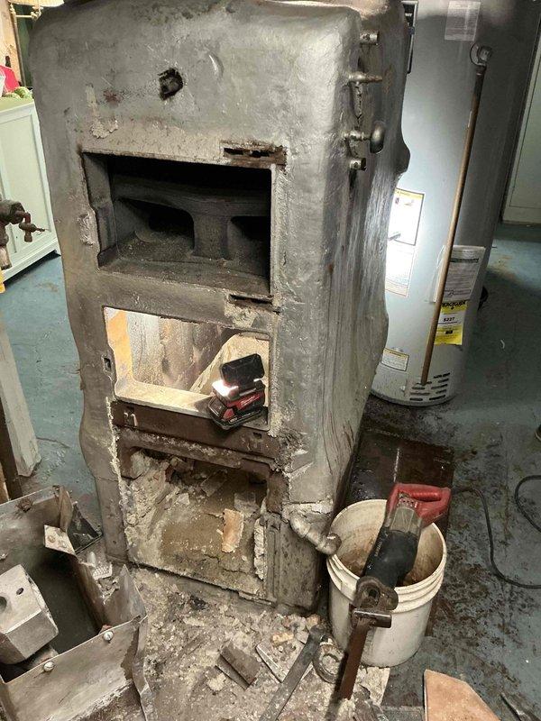 Removed and replaced severely deteriorated steam boiler system in basement mechanical room. The existing unit exhibited extensive corrosion, structural degradation, and compromised masonry housing that posed safety and efficiency concerns. Coordinated with specialized steam boiler installation crew to ensure proper removal of old equipment and professional installation of new boiler system. Additional pipe fittings and connections were installed to integrate the new unit with existing steam distribution infrastructure. System was tested and commissioned to verify proper operation and safety compliance.