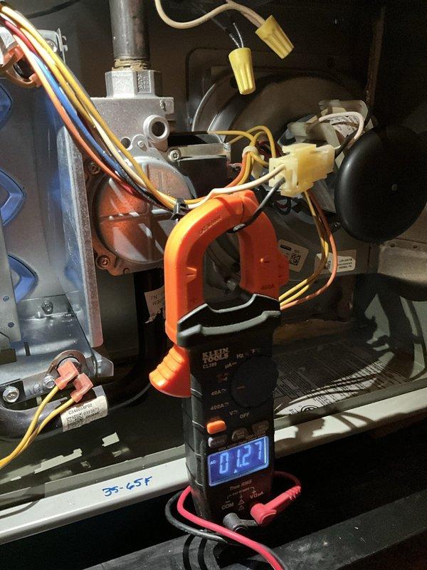 Completed comprehensive BFMA tune-up on 9+ year old air conditioning system. Performed thorough inspection of electrical connections, wiring harnesses, and control components within the unit, verifying all wire nuts and bundled connections were secure. Tested system amperage draw using digital multimeter, recording 12.7 amps, and confirmed gas valve operation and safety controls functioning properly. Verified temperature differential across the system, noting 56-65°F range marked on equipment. All electrical components, including capacitors, contactors, and safety switches inspected for proper operation. System tested and left in normal operating condition with no issues found.