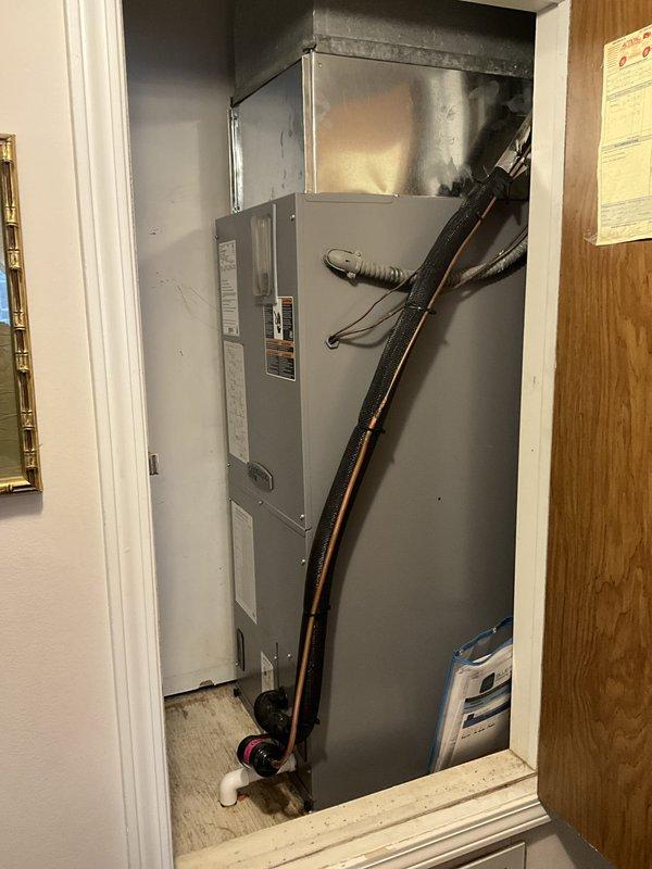 Completed comprehensive BFMA tune-up service on a 3-ton, 2-year-old split HVAC system including air conditioning unit and air handler. Performed electrical diagnostics using digital multimeter, recording voltage reading of 1369 millivolts at control panel, inspected all electrical connections, contactors, and wiring throughout the system. Cleaned and serviced air handler unit located in utility closet, inspected refrigerant lines, condensate drainage system, and all mechanical components to ensure proper operation and system efficiency.