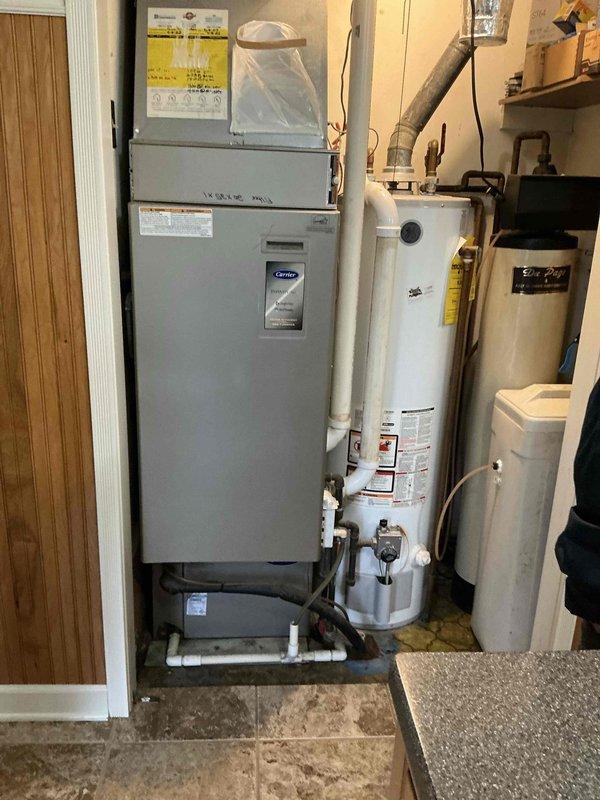 Completed full HVAC system replacement with 90% AFUE downflow furnace installation (EL297DF070XV48BK), 16 SEER 2.5-ton condenser unit (EL16KC1-030), evaporator coil (CK40DT-30/36B-71), and BFP200 thermostat with AA1410 accessory. Completely rebuilt condensation drainage system using new PVC piping and proper strapping throughout crawl space to ensure reliable operation. All equipment installed to manufacturer specifications in utility room, with proper venting, electrical connections, refrigerant charging, and system testing completed to verify full operational performance.