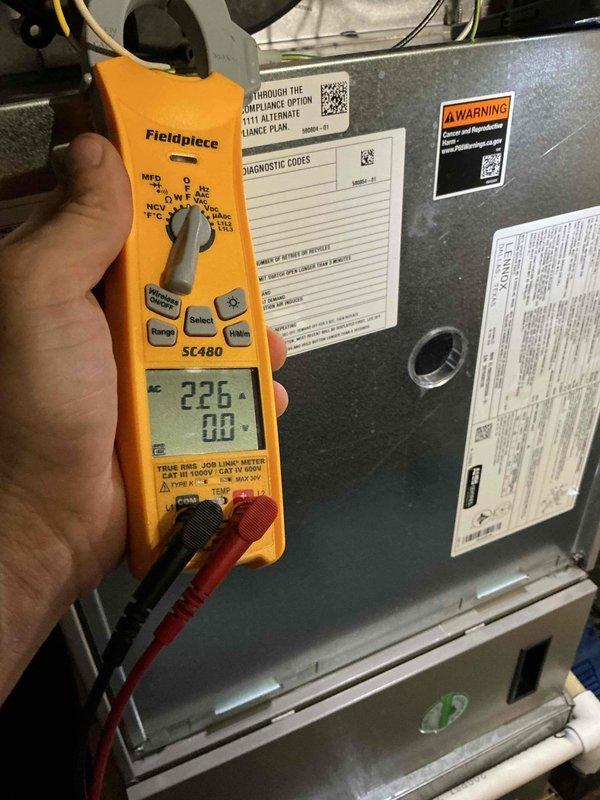 Completed comprehensive BFMA tune-up service on 7-year-old HVAC system, including both air conditioning and furnace components. Performed electrical diagnostics using clamp meter, recording voltage readings of 226V with proper amperage verification. Inspected evaporator coil assembly, noting dust and debris accumulation between aluminum fins that was cleaned to restore optimal airflow and heat transfer efficiency.