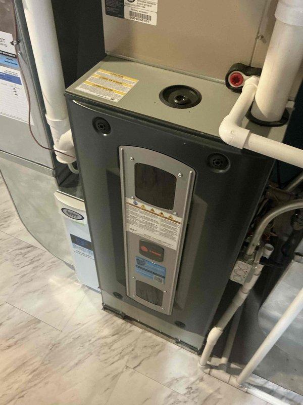 Completed comprehensive BFMA tune-up service on residential HVAC system, performing preventive maintenance on two furnace units and humidifier components. Conducted thorough inspection of gray furnace unit and associated white air handler, verified proper operation of all safety controls, cleaned burner assemblies, checked gas connections, and inspected PVC venting system for proper drainage and secure fittings. Serviced humidifier equipment, confirmed adequate water flow, and ensured all system components are operating within manufacturer specifications for optimal heating season performance.