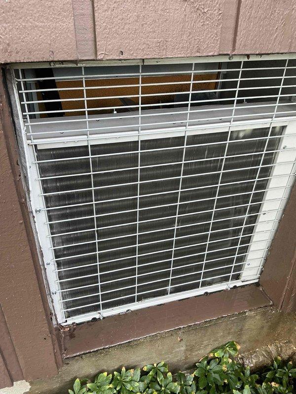 Completed comprehensive BFMA preventive maintenance tune-up on air handler system serving residential property. Equipment is approximately 4+ years old and includes both indoor air handler components and outdoor condenser unit. Performed complete system inspection, noting visible rust and corrosion present along bottom edge of condenser unit frame where metal meets concrete pad, requiring monitoring for future deterioration. Cleaned condenser coils, checked refrigerant levels, inspected electrical connections, tested thermostat operation, and verified proper airflow throughout system. All components functioning within normal operating parameters upon completion of service.