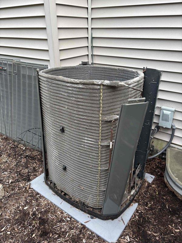 Completed comprehensive BFMA tune-up service on a 9+ year old outdoor AC condensing unit. Performed thorough inspection of the cylindrical condenser unit, which exhibited significant weathering, dirt accumulation, and rust staining on the horizontal ribbed fins. Cleaned and serviced the unit, checked electrical conduit connections, verified proper operation of all components, and ensured the system was functioning efficiently on the concrete pad foundation.