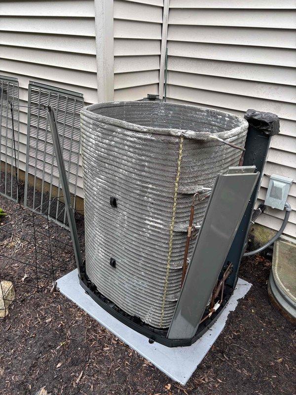 Completed comprehensive BFMA tune-up service on a 9+ year old outdoor AC condensing unit. Performed thorough inspection of the cylindrical condenser unit, which exhibited significant weathering, dirt accumulation, and rust staining on the horizontal ribbed fins. Cleaned and serviced the unit, checked electrical conduit connections, verified proper operation of all components, and ensured the system was functioning efficiently on the concrete pad foundation.