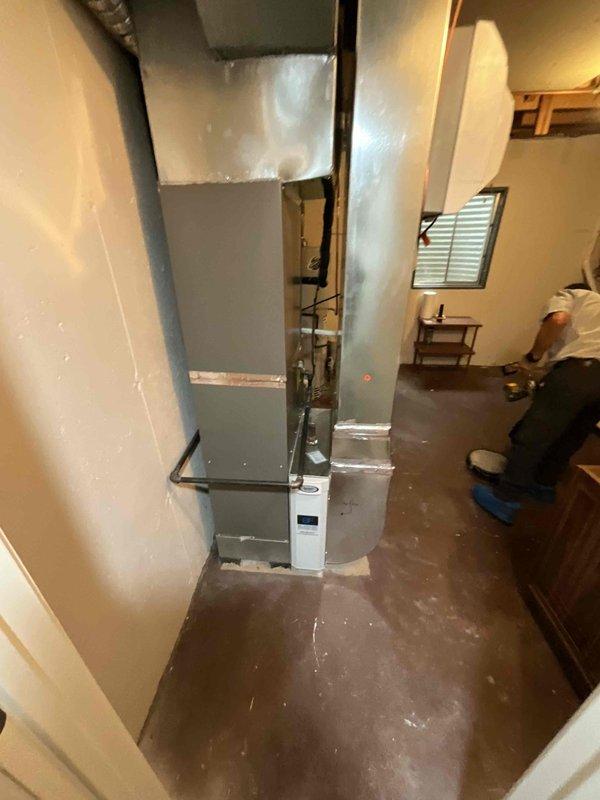 Completed comprehensive duct cleaning service for residential HVAC system in basement utility area. Performed thorough cleaning of ductwork connected to vertical air handler unit, removing accumulated dust, debris, and particulate matter from interior duct surfaces as evidenced by pre-cleaning documentation. System sanitized and verified for proper airflow upon completion.