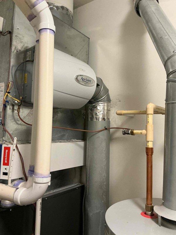 Replaced existing bypass humidifier with new Aprilaire unit mounted to main supply duct. Installed inline water filter on copper supply line with shutoff valve to protect humidifier from sediment and mineral buildup. Verified proper electrical connections, tested water flow through filter assembly, and confirmed humidifier operation with HVAC system.