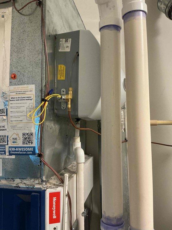 Replaced existing bypass humidifier with new Aprilaire unit mounted to main supply duct. Installed inline water filter on copper supply line with shutoff valve to protect humidifier from sediment and mineral buildup. Verified proper electrical connections, tested water flow through filter assembly, and confirmed humidifier operation with HVAC system.