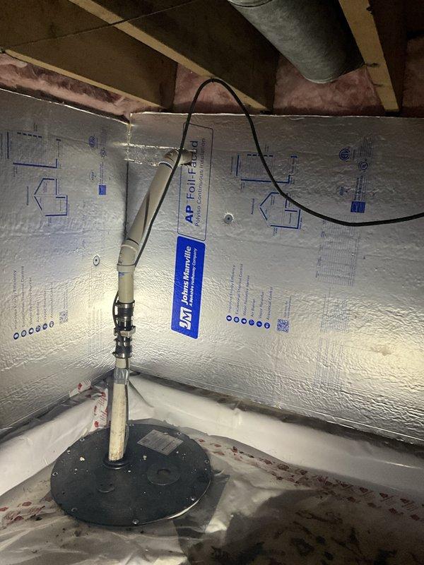 Responded to water accumulation issue in sub-basement where sump pump discharge piping was not draining properly and remained filled with water. Upon inspection, confirmed that water was not moving away from the house as reported. Assessed the sump pump system, discharge line configuration, and drainage pathway in the crawl space area. Documented existing conditions including the pump installation, discharge piping routing through the floor system, and surrounding insulation and vapor barrier materials to identify potential blockages or drainage issues preventing proper water evacuation from the property.