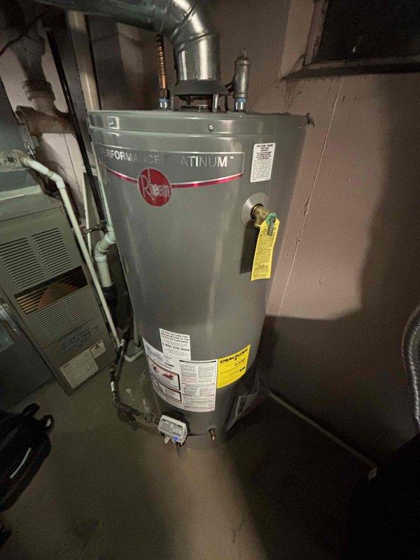 Completed comprehensive furnace tune-up on 3-year-old unit, performing standard maintenance protocol including combustion analysis with digital analyzer showing temperature differentials and system performance metrics within manufacturer specifications. Inspected all mechanical components, verified proper operation of heating system, and documented equipment condition alongside water heater installation in mechanical room.