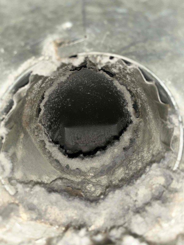 Completed comprehensive duct cleaning service for residential HVAC system. Pre-service inspection revealed significant accumulation of dust, lint, and airborne debris throughout the ductwork, with several millimeters of fibrous particulate matter coating interior surfaces and concentric buildup in circular duct sections. Thoroughly cleaned all accessible ductwork, removed accumulated contaminants from metal plenum sections and ventilation components, and restored proper airflow pathways throughout the system.