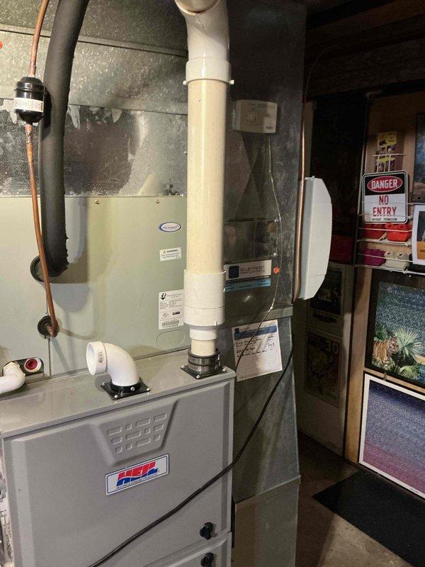 Conducted sales estimate for furnace replacement following discovery of cracked heat exchanger during previous diagnostic call. Existing furnace located in mechanical room alongside water heater, with PVC exhaust venting system in place. Assessed current HVAC configuration and prepared replacement proposal for residential forced-air heating system to restore safe heating operation.