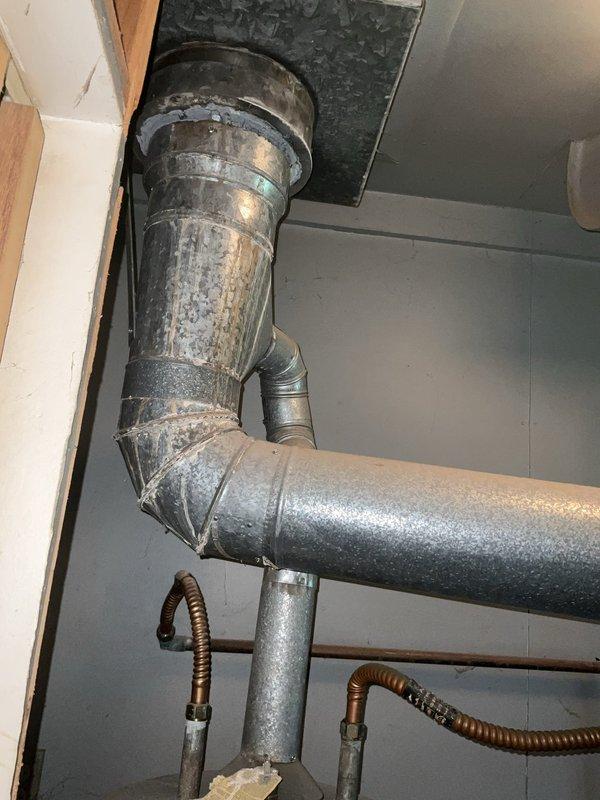 Conducted comprehensive assessment of existing hydronic heating system including aged copper manifold piping with visible oxidation, expansion tank, and associated zone valves. Evaluated ductwork routing through attic space and refrigerant line configuration to determine equipment replacement specifications and system upgrade requirements for boiler replacement estimate.