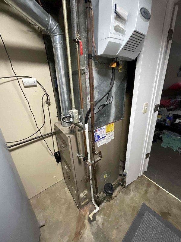 Completed comprehensive estimate for residential HVAC furnace system replacement in utility room. Evaluated existing furnace unit, ductwork configuration, electrical connections, and clearance requirements for new equipment installation. Documented current system specifications including metallic furnace housing, refrigerant lines, supply and return ductwork, and integration with existing water heater placement to provide accurate replacement recommendations and ensure proper sizing for heating demands.