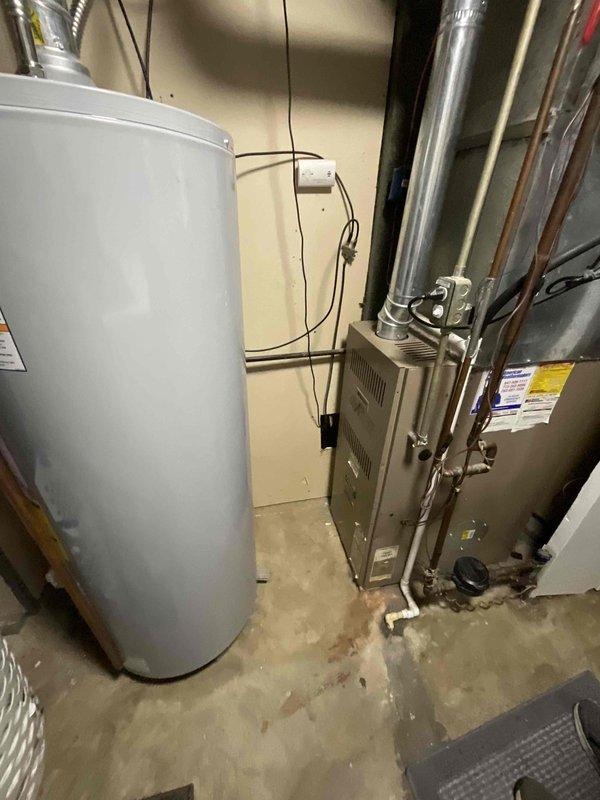 Completed comprehensive estimate for residential HVAC furnace system replacement in utility room. Evaluated existing furnace unit, ductwork configuration, electrical connections, and clearance requirements for new equipment installation. Documented current system specifications including metallic furnace housing, refrigerant lines, supply and return ductwork, and integration with existing water heater placement to provide accurate replacement recommendations and ensure proper sizing for heating demands.