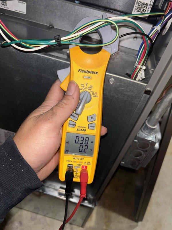 Completed comprehensive BFMA tune-up service on residential Lennox air conditioning system and furnace unit, both 3+ years old. Performed full system diagnostics using clamp meter to verify electrical readings, measured operating amperage at 0.38A with temperature readings at 71.6°F, inspected outdoor condenser unit positioned on concrete pad showing normal weathering, checked all electrical connections and disconnect box, verified proper refrigerant line installation and PVC drainage system functionality, and confirmed both heating and cooling systems operating within manufacturer specifications.