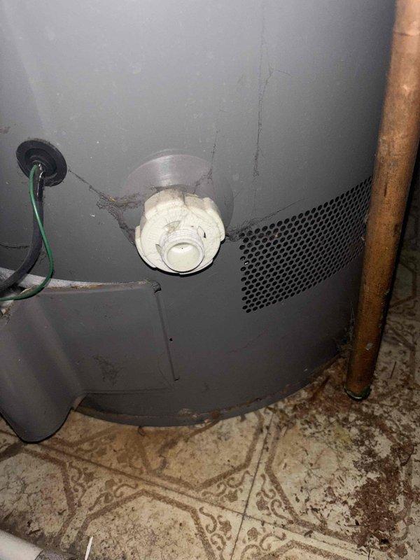 Completed comprehensive BFMA tune-up service including furnace and humidifier maintenance on 10-year-old equipment. Performed standard inspection, cleaning, and adjustment procedures on heating system and humidifier unit to ensure optimal winter operation. Documented existing water heater showing significant age-related wear, heavy mineral buildup on temperature and pressure relief valve, and evidence of hard water conditions; also noted contaminated condensate drain pan with brown staining and biological growth requiring attention during future service visit.