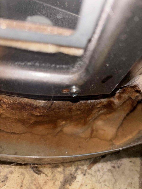 Completed comprehensive BFMA tune-up service including furnace and humidifier maintenance on 10-year-old equipment. Performed standard inspection, cleaning, and adjustment procedures on heating system and humidifier unit to ensure optimal winter operation. Documented existing water heater showing significant age-related wear, heavy mineral buildup on temperature and pressure relief valve, and evidence of hard water conditions; also noted contaminated condensate drain pan with brown staining and biological growth requiring attention during future service visit.