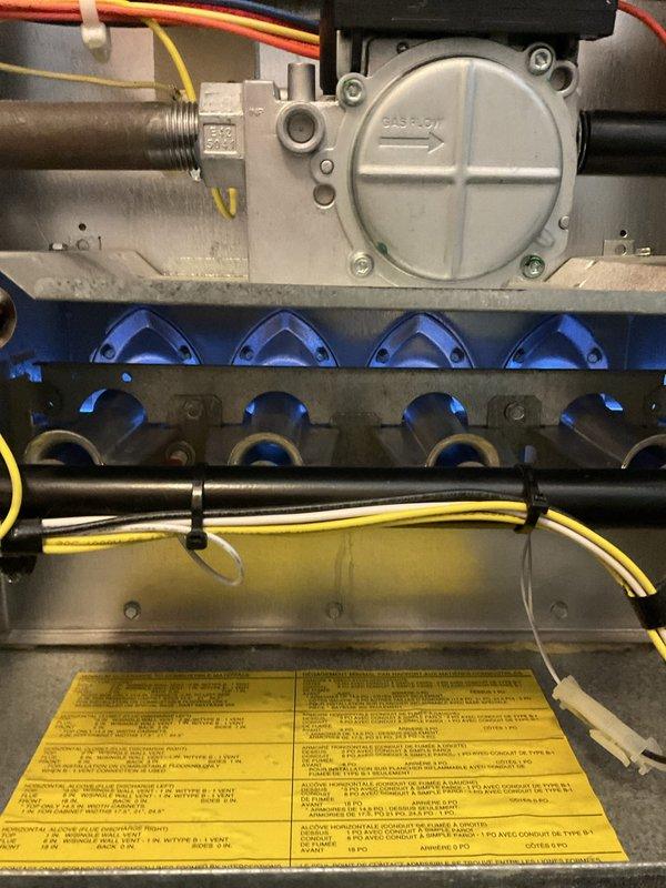Completed comprehensive furnace and air conditioning tune-up on 4-year-old Trane XV80 system. Performed full inspection of gas valve, burner assembly, and heat exchanger, confirmed proper operation of all burners with characteristic blue flame pattern, verified electrical connections and wire management throughout unit, and documented equipment condition with photographs. All components found to be operating within manufacturer specifications with no deficiencies noted.