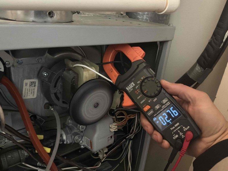 Inspected HVAC system following report of high inducer motor amperage draw. Performed diagnostic testing with clamp meter and confirmed inducer motor operating within normal parameters at 2.16 amps, significantly lower than previously reported 3-amp reading. Inspected flue piping for blockages and verified clear ventilation pathway. All electrical connections, gas valve, and blower assembly components checked and found in proper working condition.