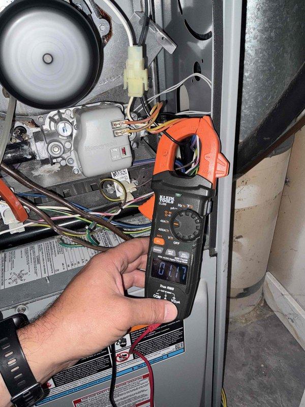 Inspected HVAC system following report of high inducer motor amperage draw. Performed diagnostic testing with clamp meter and confirmed inducer motor operating within normal parameters at 2.16 amps, significantly lower than previously reported 3-amp reading. Inspected flue piping for blockages and verified clear ventilation pathway. All electrical connections, gas valve, and blower assembly components checked and found in proper working condition.