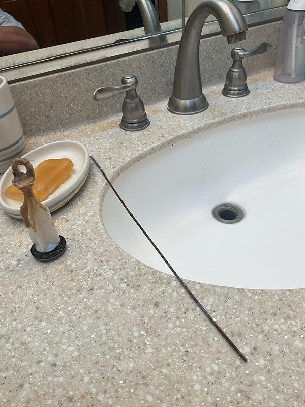 Responded to clogged drain service call at residential property. Upon arrival, inspected bathroom vanity sink and determined blockage was affecting drainage. Cleared obstruction from drain line and verified proper water flow through fixture. Tested drainage system to ensure complete resolution and proper operation of plumbing components.