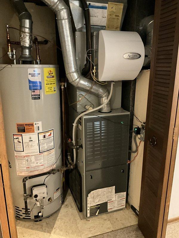 Responded to after hours service call for residential HVAC system. Upon arrival, inspected furnace, water heater, humidifier, and thermostat to diagnose reported issue. Thermostat displayed 72°F setpoint with system in heating mode and fan operation confirmed. Verified all equipment connections, ductwork, and Aprilaire humidifier installation in utility closet were secure and functioning properly.