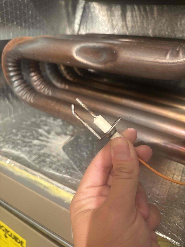 Completed comprehensive BFMA tune-up service including furnace inspection, air conditioning system maintenance, and dryer vent cleaning. Inspected heat exchanger coils and noted progressive corrosion on lower copper tubing sections with oxidation present, while upper coils remain in good condition. Examined and tested flame sensor for proper operation, verified all safety controls, cleaned components as needed, and documented system condition with photographic evidence for maintenance records.